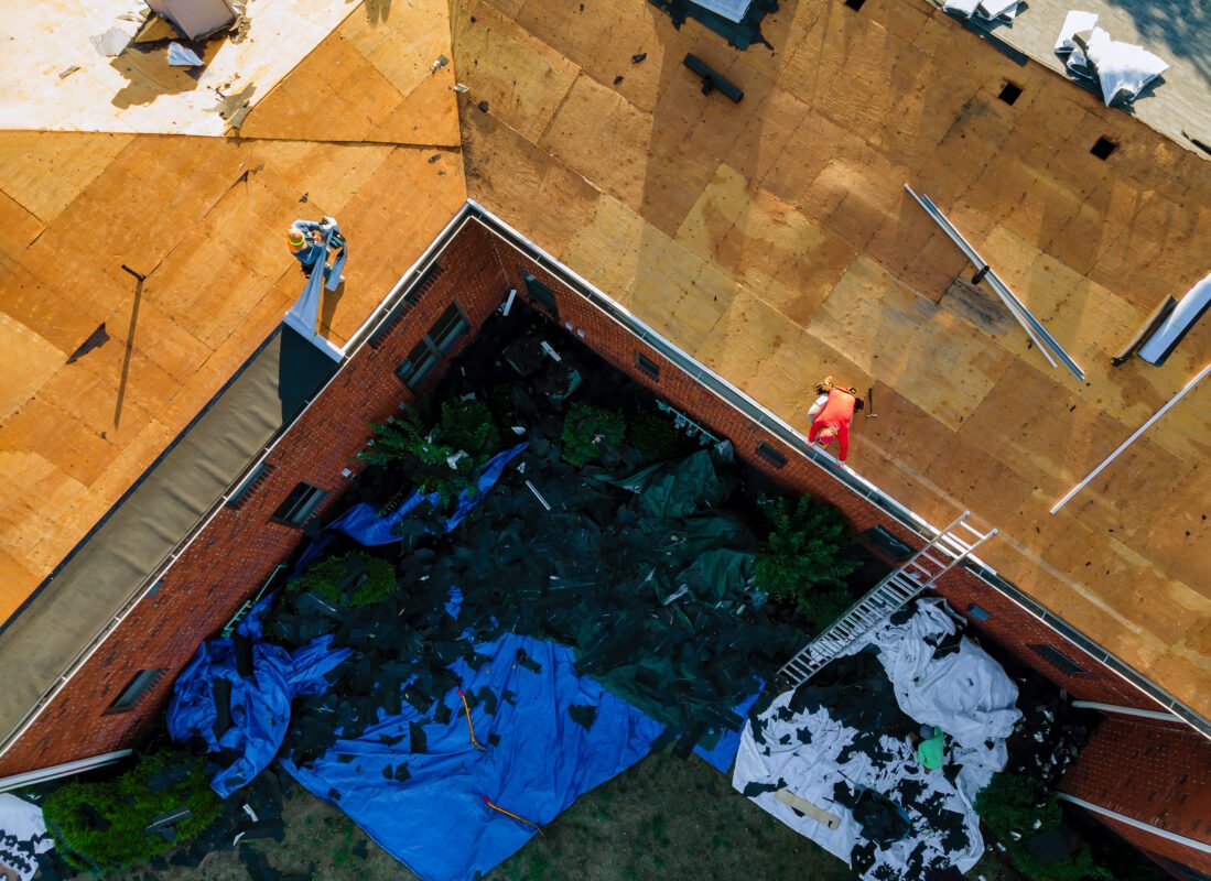 Construction worker on a replacement shingles roof the house installed new shingles