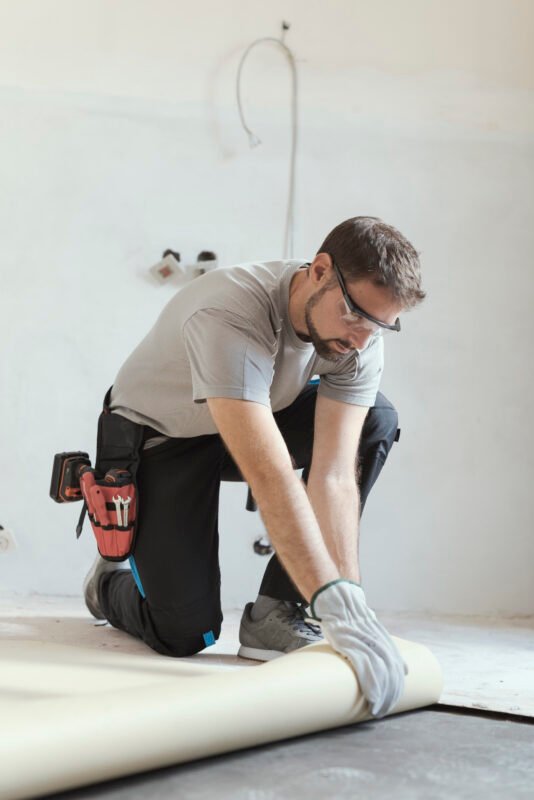 Contractor removing an old linoleum flooring
