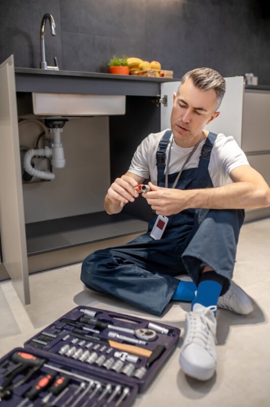 Man looking at detail sitting on floor