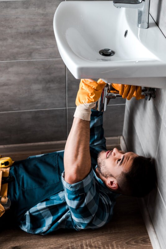 Handyman fixing water damage in bathroom